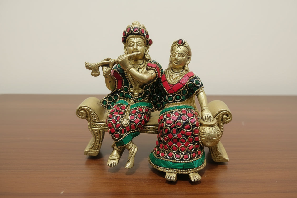 Brass Radha Krishna Statue with Stonework – Divine Couple Sitting on Sofa for Home Décor & Gifting