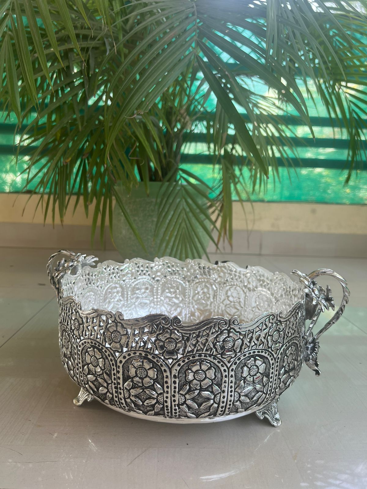 German silver fully carved round designer urli/basket with flower handles
