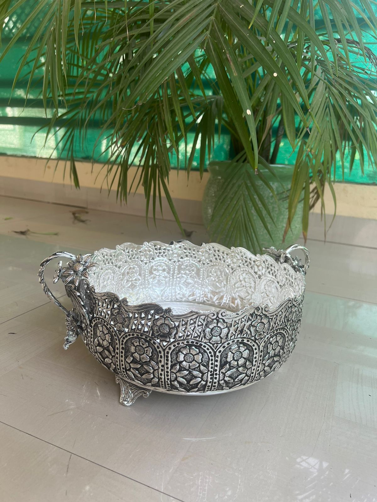 German silver fully carved round designer urli/basket with flower handles