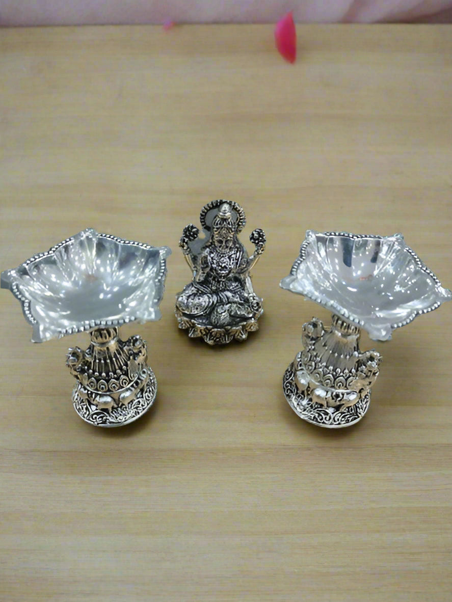 Silver Plated Lakshmi Idol with 2 Diya Silver Plated with Fully Carved Peacock Design