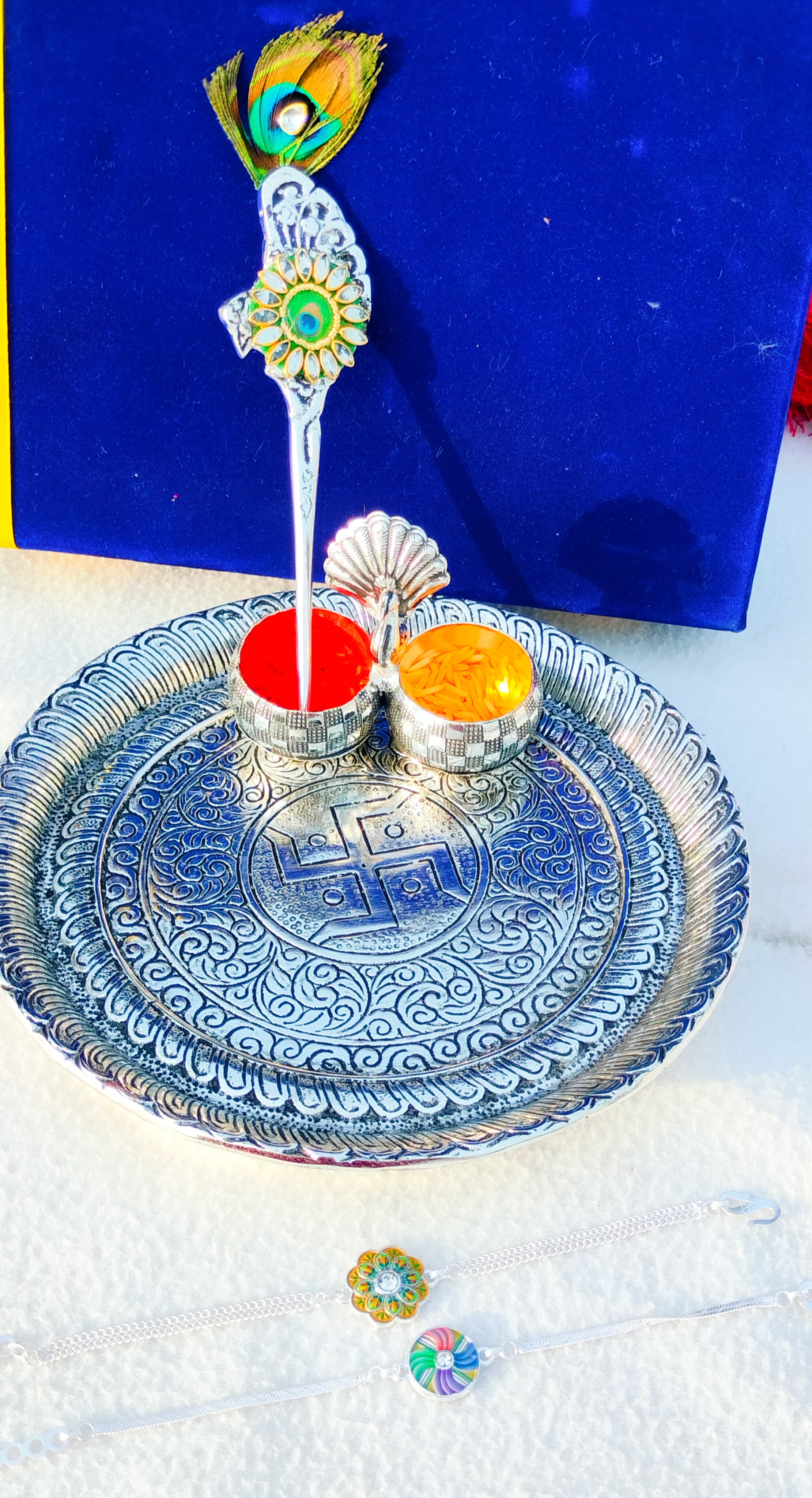 German silver Ghungaru thali with peacock kumkum bowl & tilak stick with 2 pure silver rakhi set