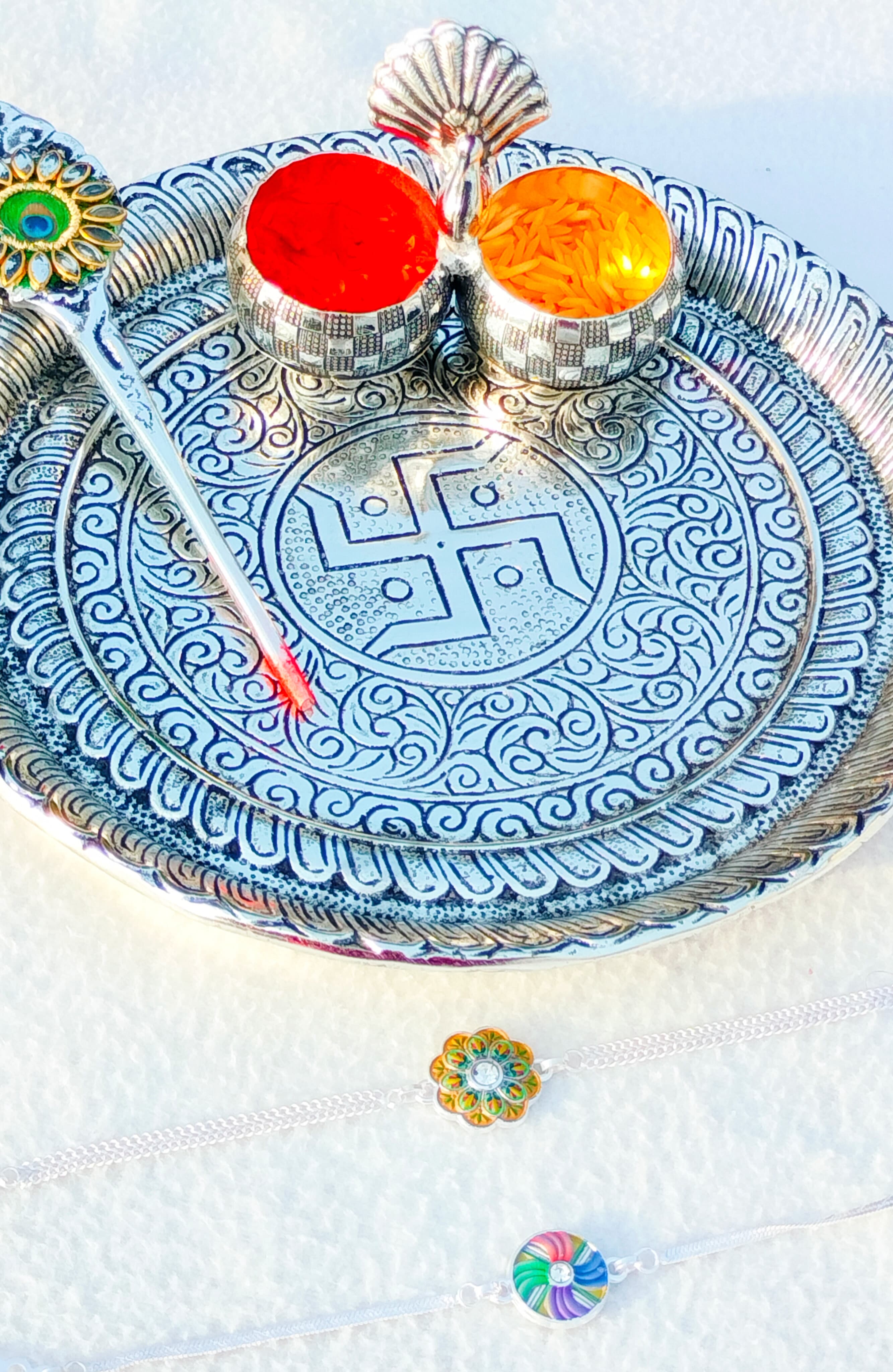 German silver Ghungaru thali with peacock kumkum bowl & tilak stick with 2 pure silver rakhi set