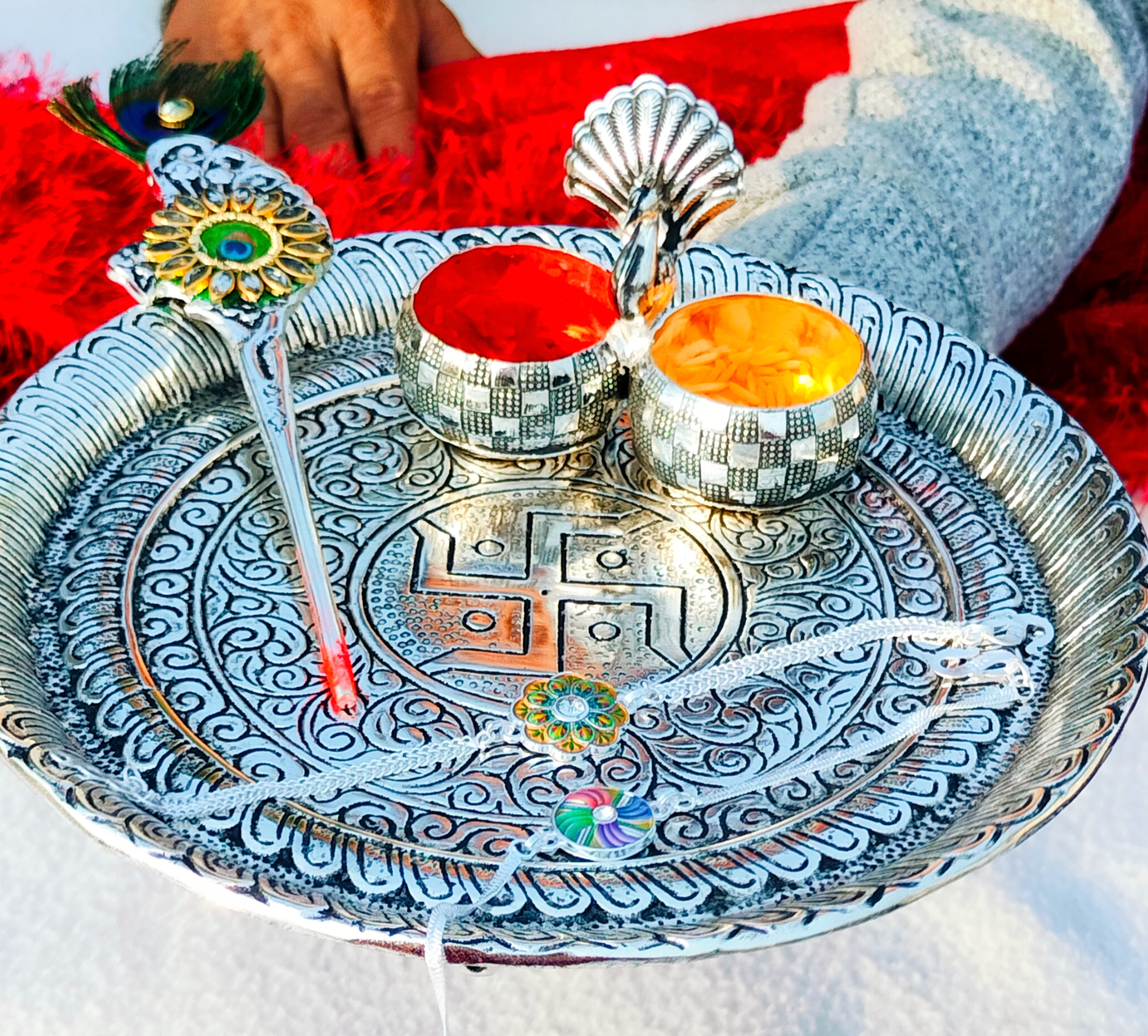 German silver Ghungaru thali with peacock kumkum bowl & tilak stick with 2 pure silver rakhi set