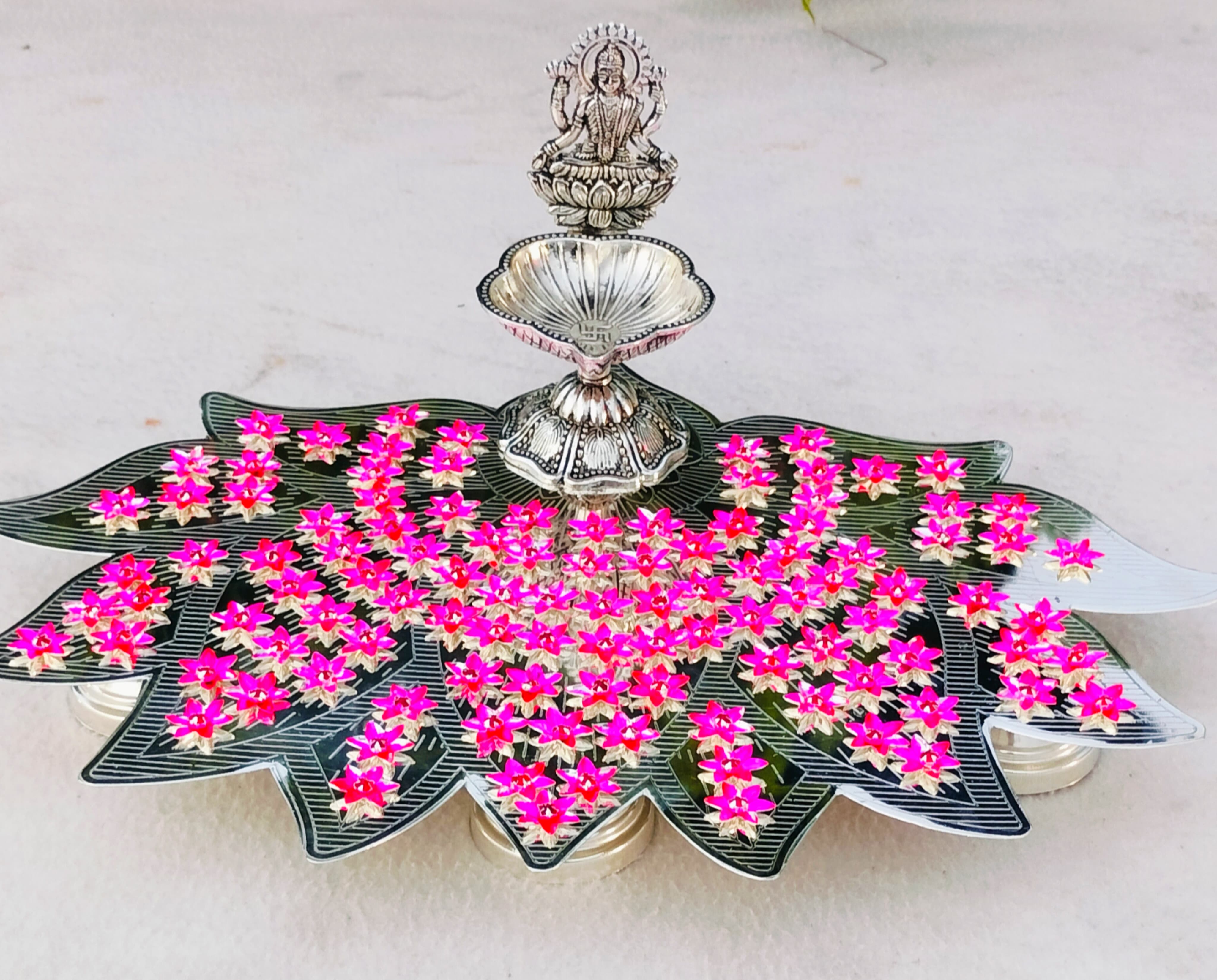 German silver lotus Ashtotram stand with 108 pink parijatham flower with lakshmi diya