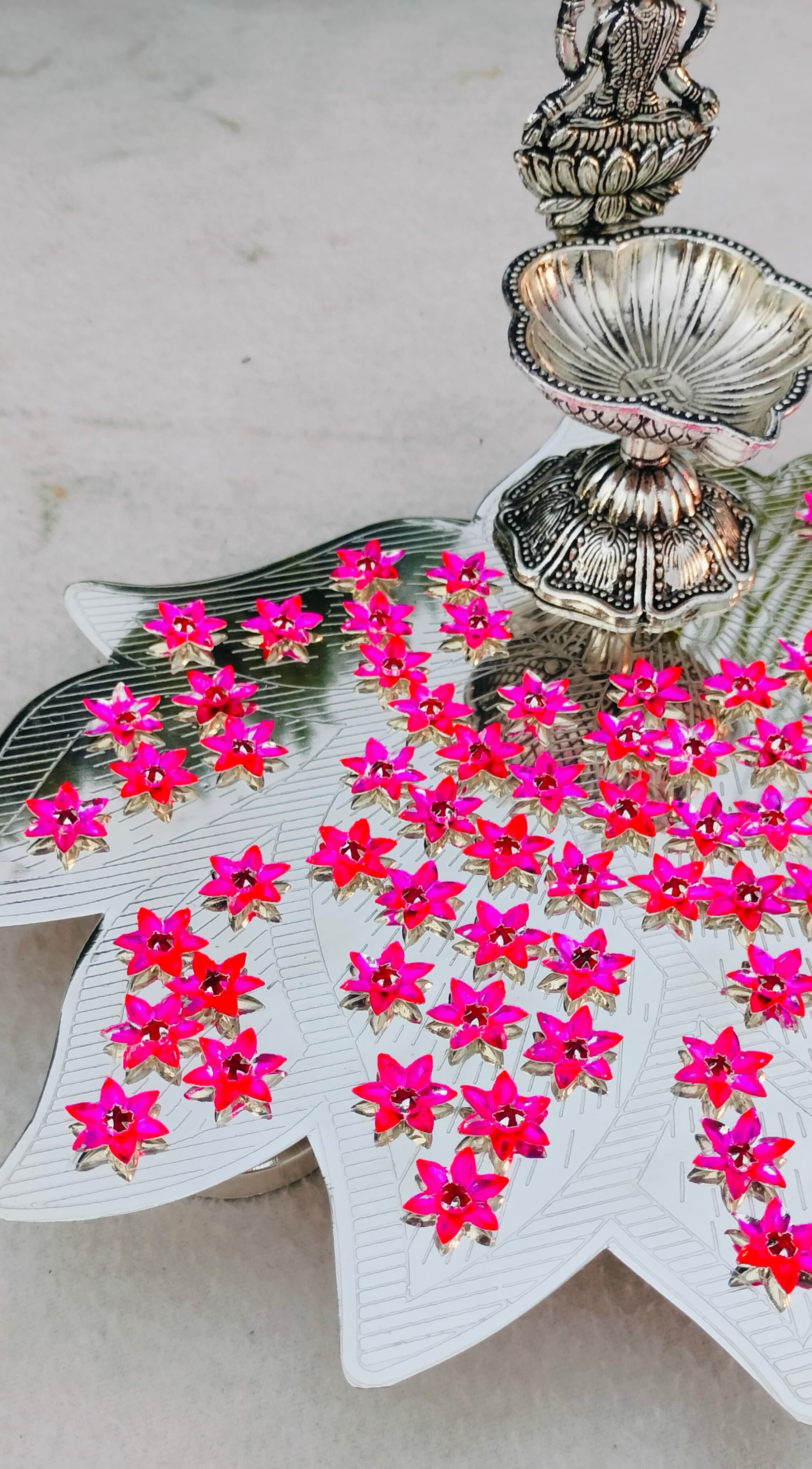 German silver lotus Ashtotram stand with 108 pink parijatham flower with lakshmi diya