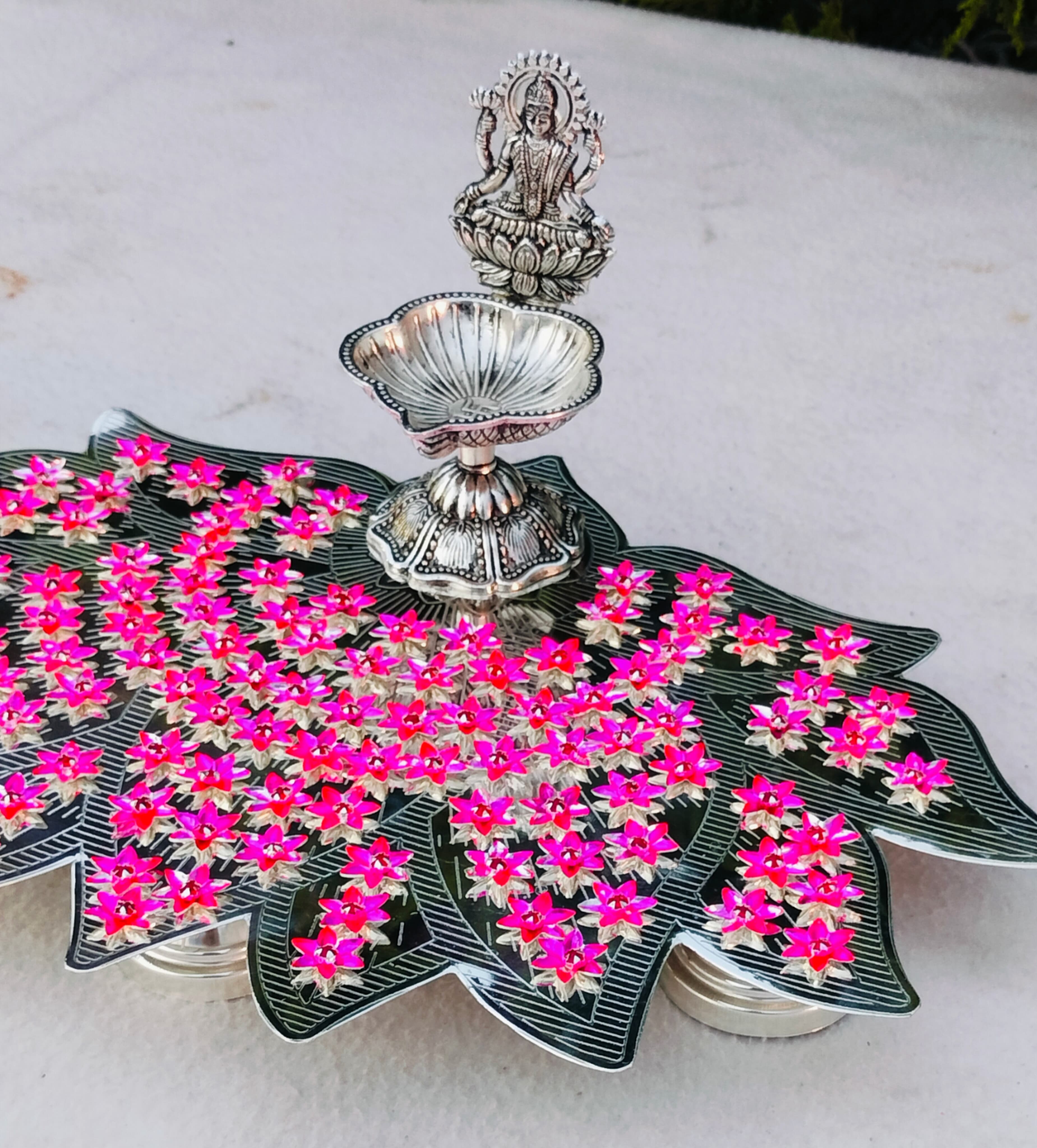 German silver lotus Ashtotram stand with 108 pink parijatham flower with lakshmi diya