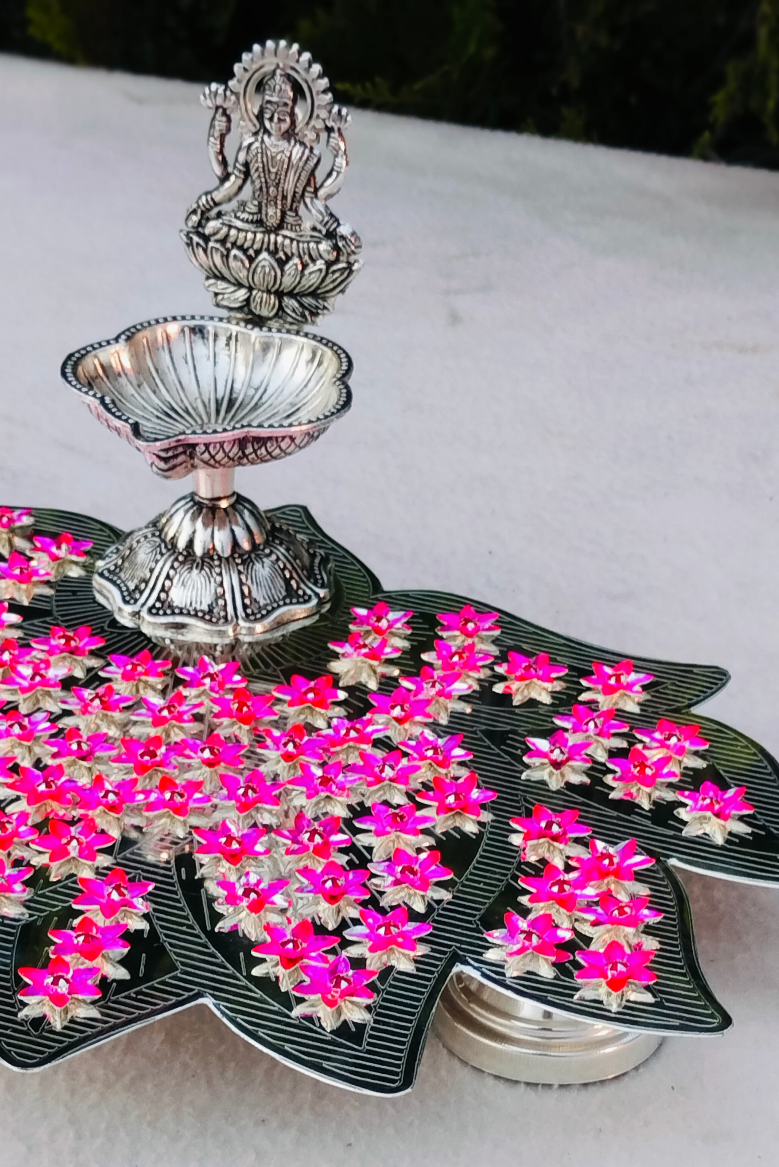 German silver lotus Ashtotram stand with 108 pink parijatham flower with lakshmi diya
