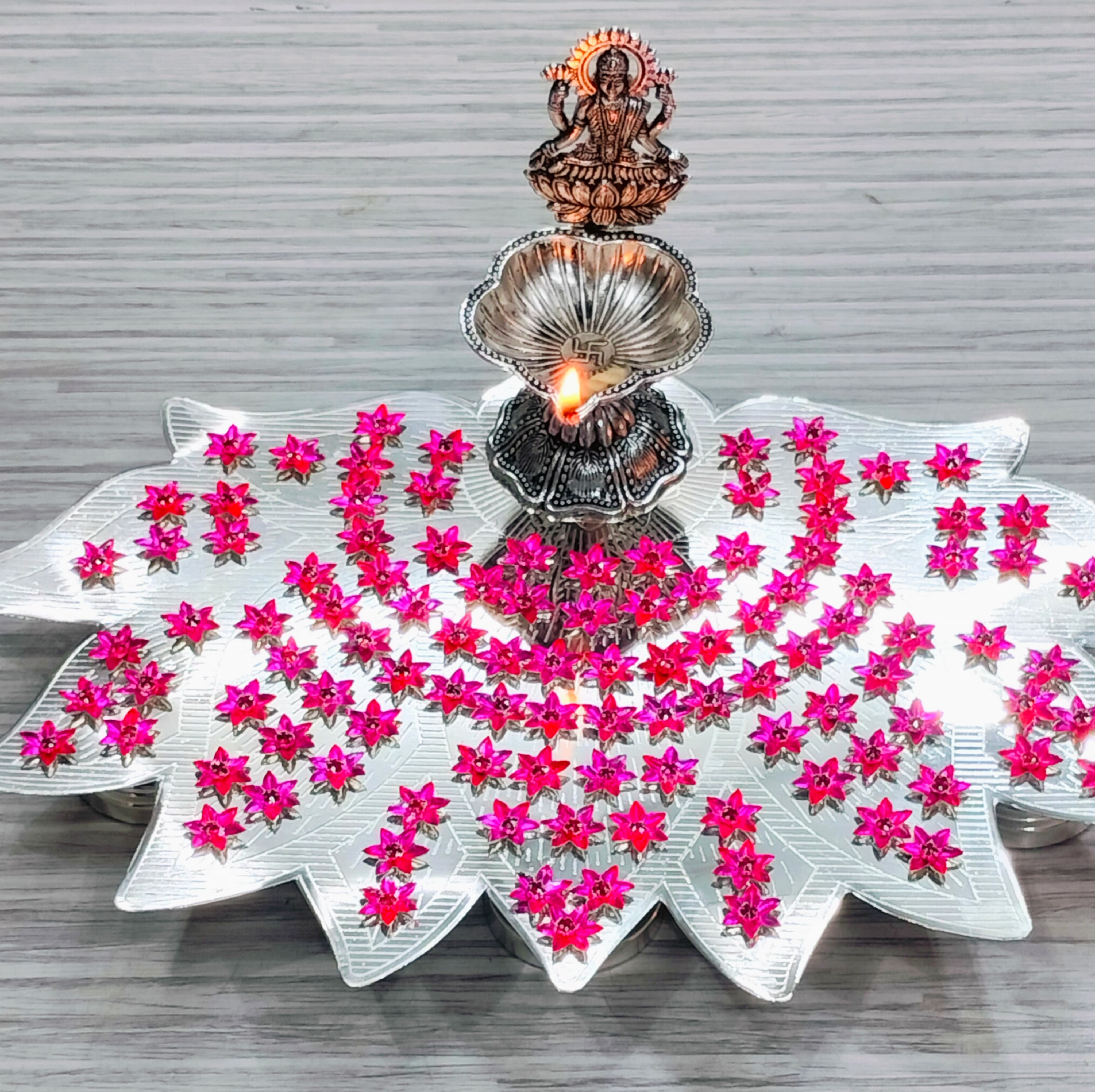 German silver lotus Ashtotram stand with 108 pink parijatham flower with lakshmi diya