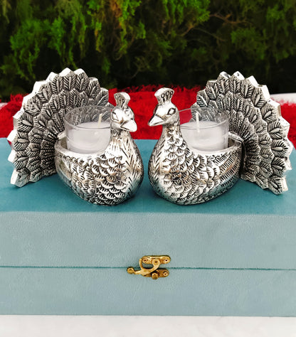 Antique finish German silver peacock pair with glass candle holder