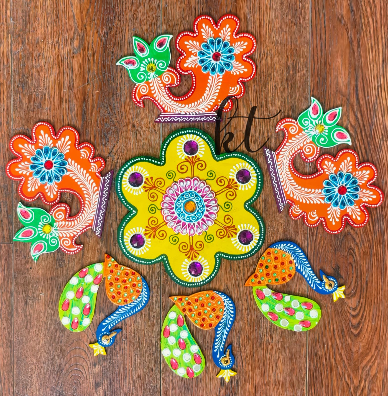 Reusable multicolor MDF rangoli set featuring intricate hand-painted designs, decorative mirrors, and stone work for Diwali décor.