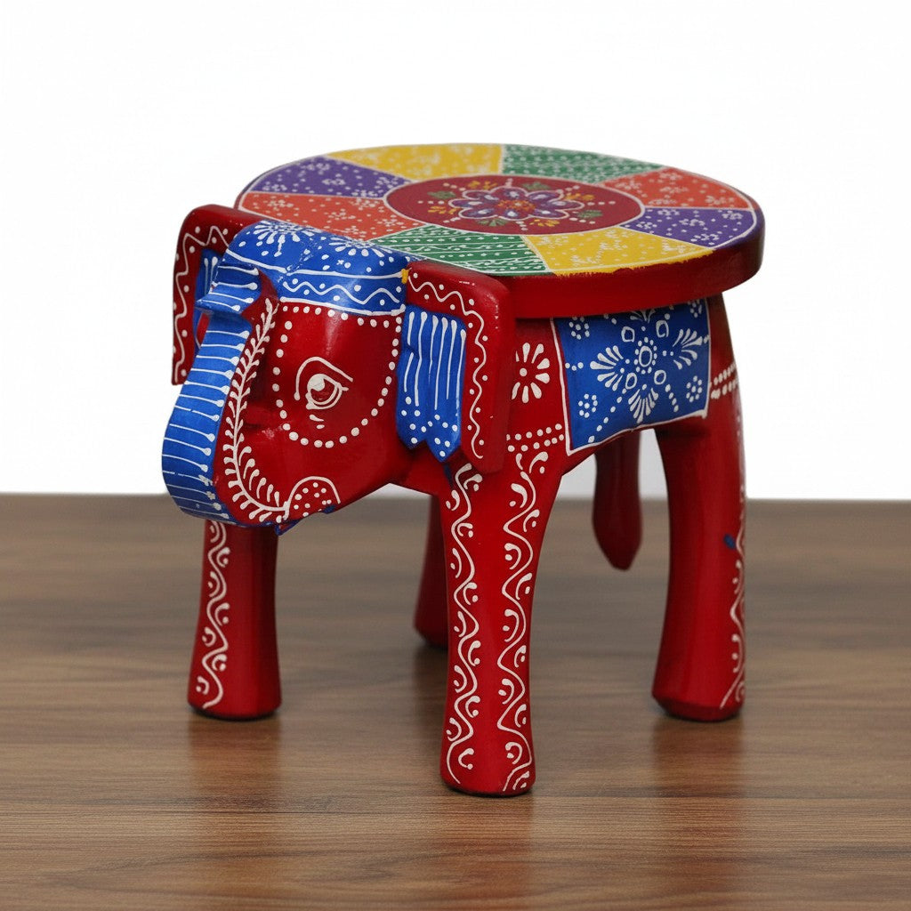 Decorative red wooden elephant stool featuring traditional hand-painted artwork and intricate embossed detailing, ideal for ethnic and bohemian home décor.