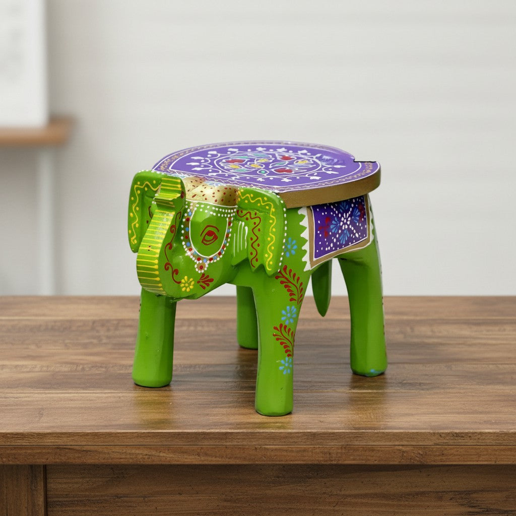 Decorative green wooden elephant stool featuring traditional hand-painted artwork and intricate embossed detailing, ideal for ethnic and bohemian home décor.