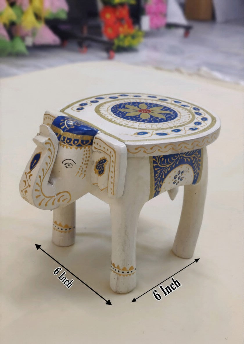 Decorative white wooden elephant stool featuring traditional hand-painted artwork and intricate embossed detailing, ideal for ethnic and modern home décor.