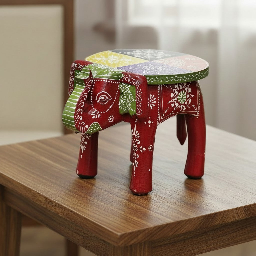 Decorative maroon wooden elephant stool featuring traditional hand-painted artwork, ideal for ethnic home décor and collectible displays.    