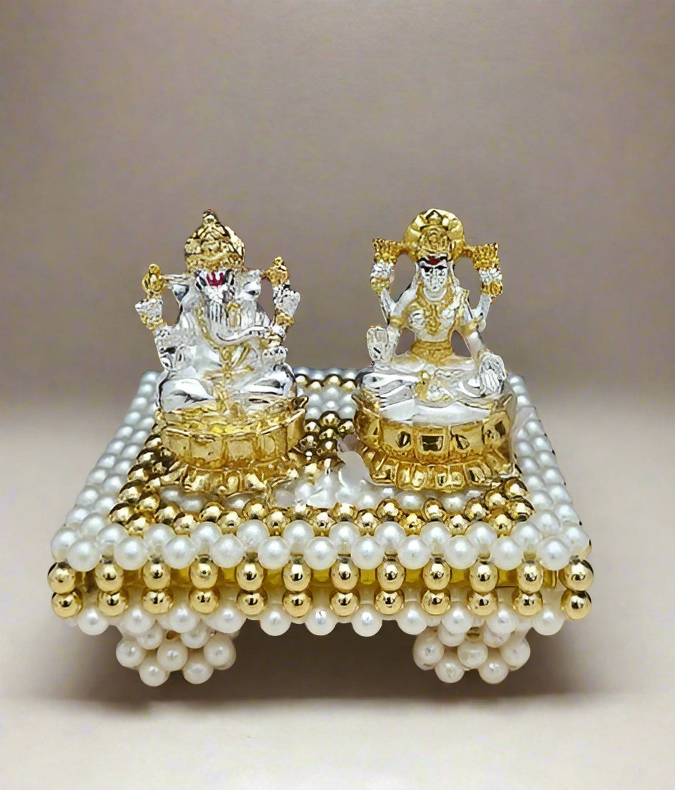 golden and silver resin lakshmi Ganesh idol with stool