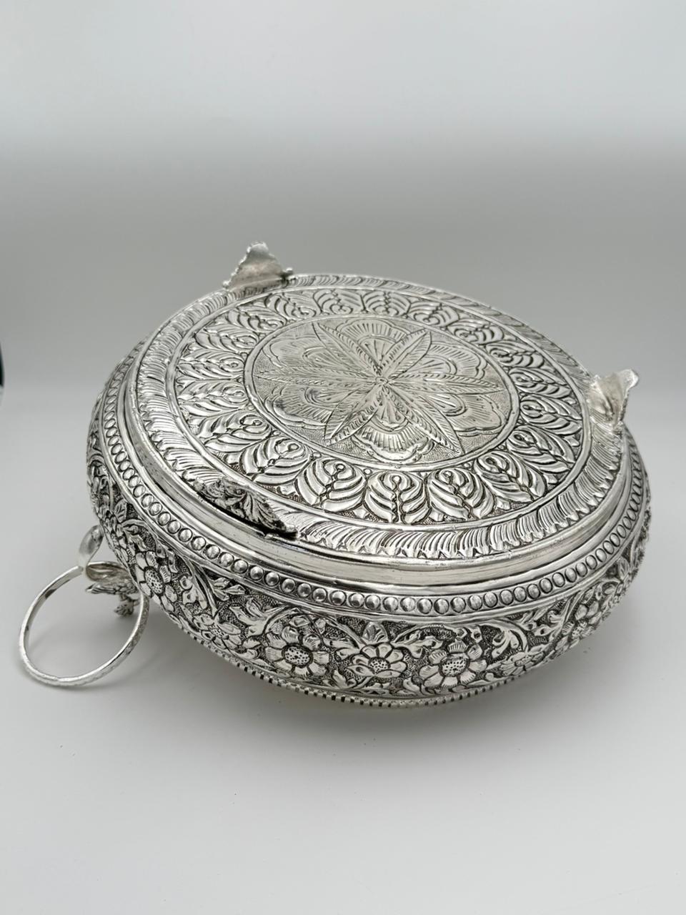 Traditional German silver peacock urli bowl with carved antique design, elegant festive décor accent for floating flowers, candles, and cultural celebrations.