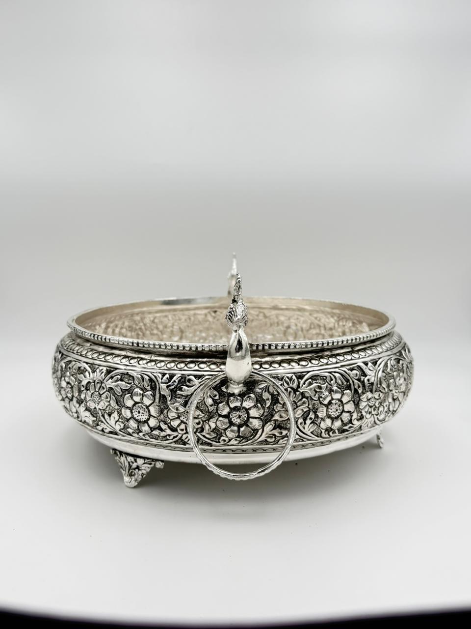 Traditional German silver peacock urli bowl with carved antique design, elegant festive décor accent for floating flowers, candles, and cultural celebrations.