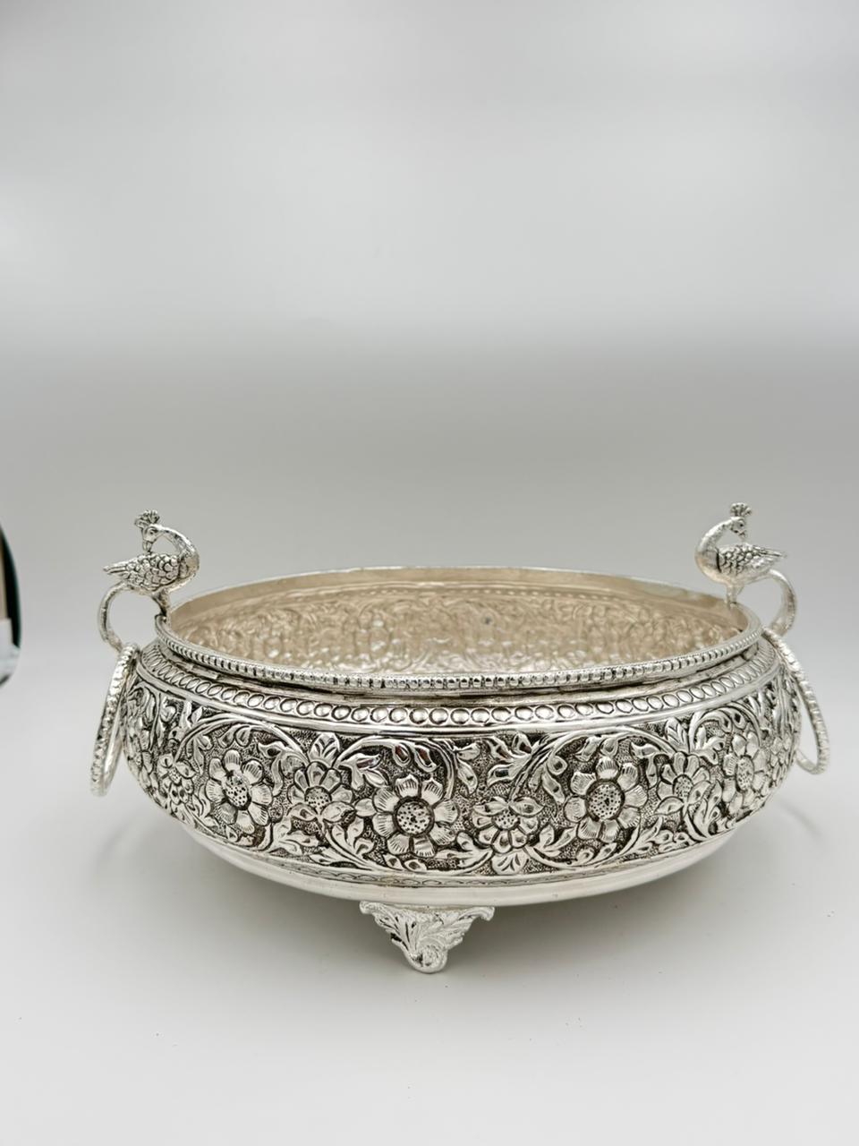 Traditional German silver peacock urli bowl with carved antique design, elegant festive décor accent for floating flowers, candles, and cultural celebrations.