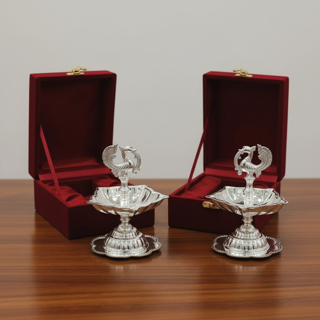 Premium set of 2 peacock diya made of German silver, each placed in individual velvet boxes, designed for Diwali celebrations, pooja rituals, home temple décor, and festive gifting.