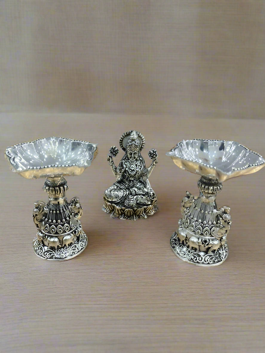 Silver Plated Lakshmi Idol with 2 Diya Silver Plated with Fully Carved Peacock Design