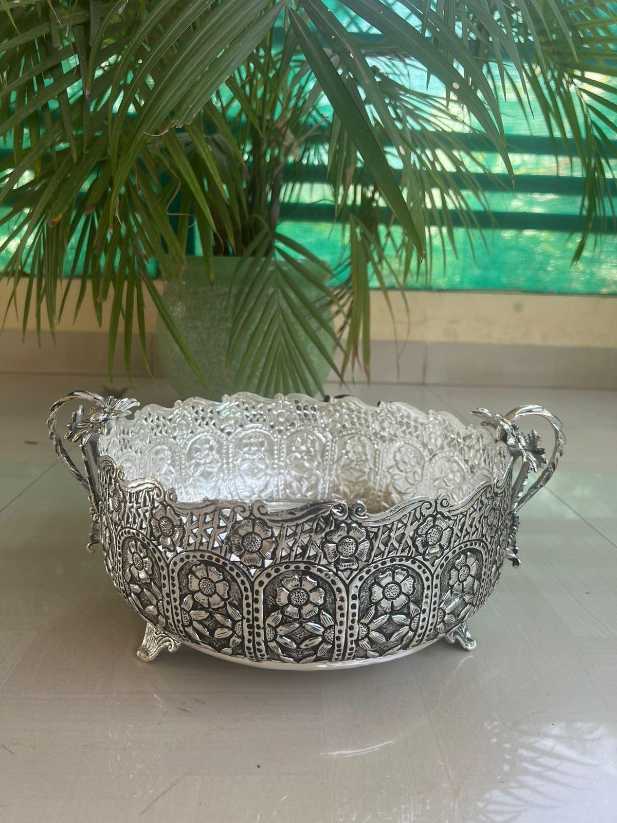 German silver fully carved round designer urli/basket with flower handles