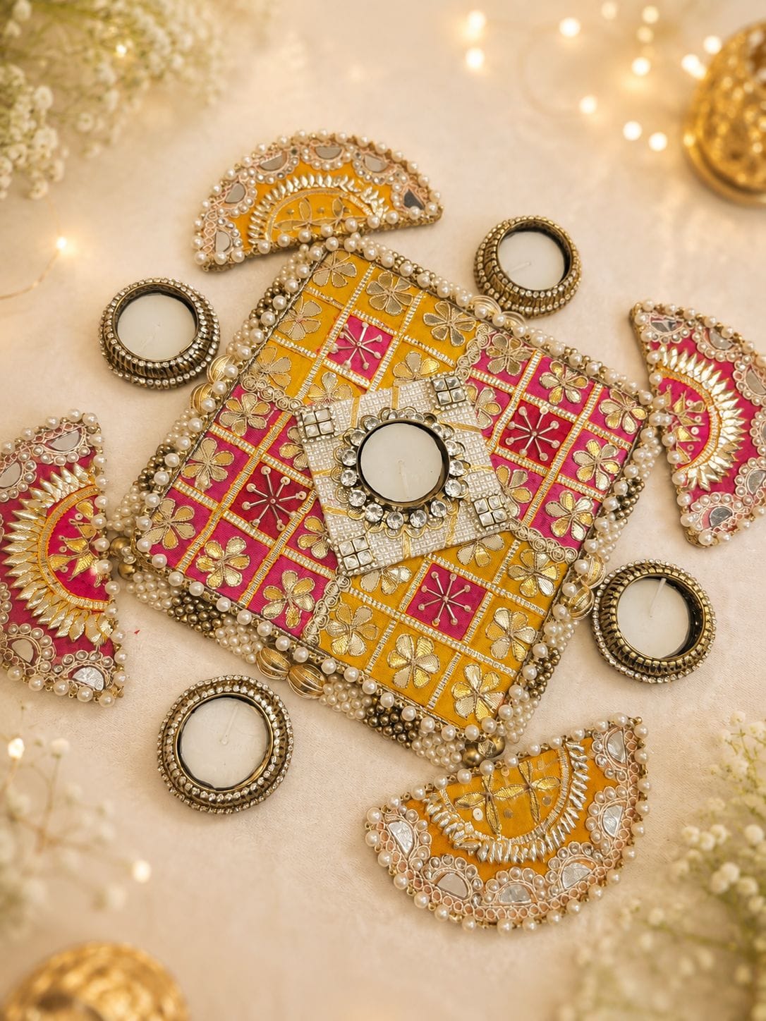 Set of 9 gota patti work rangoli mat set with MDF base and metal tea light holders including 1 center piece (7x7 inches), 4 semi-circle side pieces (5x2.5 inches), and 4 metal diyas for Diwali floor decor.
