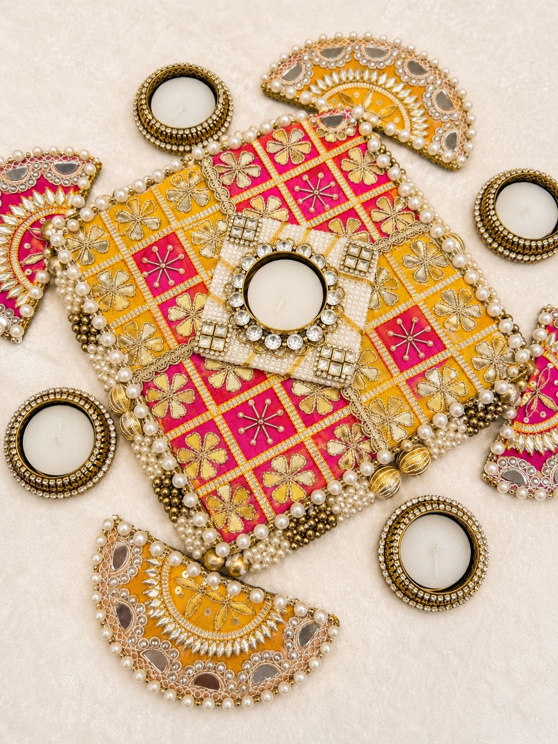 Set of 9 gota patti work rangoli mat set with MDF base and metal tea light holders including 1 center piece (7x7 inches), 4 semi-circle side pieces (5x2.5 inches), and 4 metal diyas for Diwali floor decor.