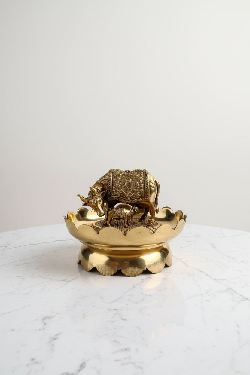 Handcrafted brass Kamdhenu cow and calf statue on a decorative lotus stand, ideal for pooja rooms, home temples, Vastu décor, spiritual spaces, and religious gifting. 🐄🌸✨🙏