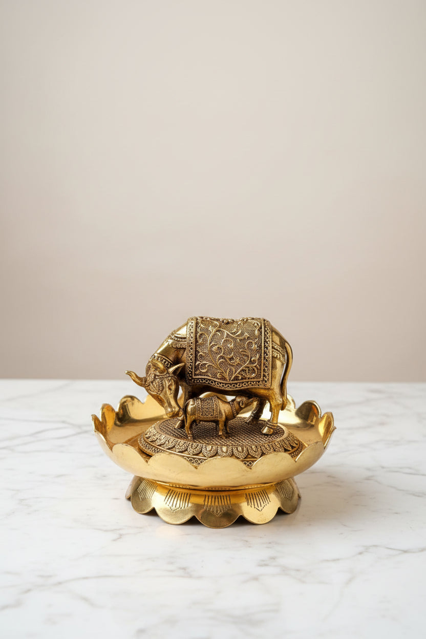 Handcrafted brass Kamdhenu cow and calf statue on a decorative lotus stand, ideal for pooja rooms, home temples, Vastu décor, spiritual spaces, and religious gifting. 🐄🌸✨🙏